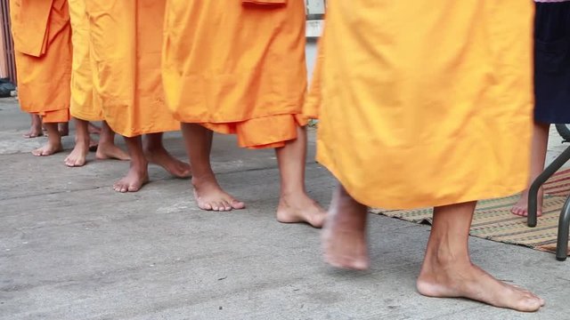 monk walking for receive food in morning time