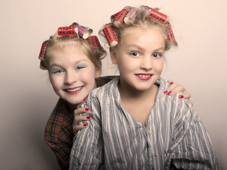 two teenager girls playing Housewives, do yourself hairstyles and makeup having fun