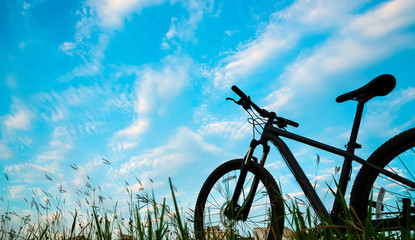 Fototapeta na wymiar Silhouette Mountain biking, down hill at sunset