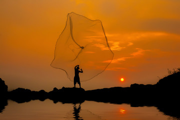 Fisherman fishing at sunset.