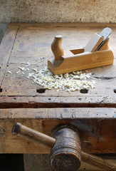 Planer and sawdust in an antique wooden Workbench with vise