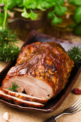 Roast pork with herbs and vegetables.