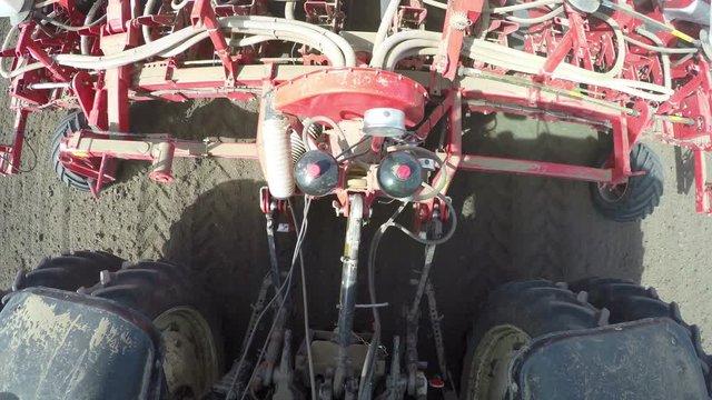 Tractor with sowing machine planting seeds