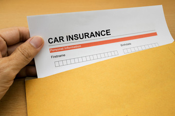 Car Insurance application form on brown envelope