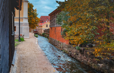 Brook among medieval buildings in Kuldiga town, Latvia, Europe