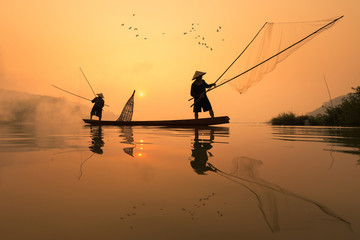 Fishermans is fishing in Mekong river in the morning at Nongkhai province, Thailand - obrazy, fototapety, plakaty