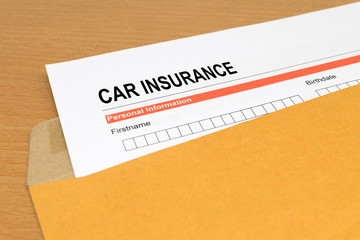 Car Insurance application form on brown envelope