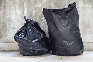 close-up of a full garbage bags on floor