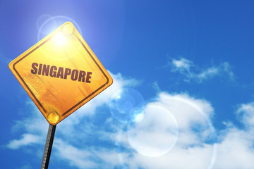 Yellow road sign with a blue sky and white clouds: Greetings fro