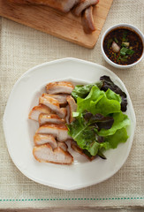 cut pork chop and vegetable in plate with spicy sauce,thai food