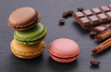 Sweet and colourful french macaroons  on a grey  background.