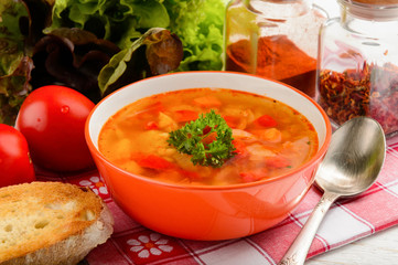 Red lentil soup on wooden table.
