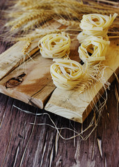 Uncooked pasta with flour on the table, selective focus