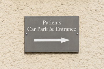 Patients Car Park and Entrance sign on wall outside Doctors surg