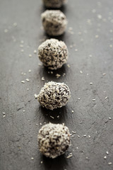 Homemade Healthy Paleo Raw Chocolate Truffles with Nuts, Dates and Coconut Flakes Put in Line