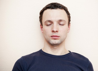 Obraz premium Young Caucasian man with closed eyes