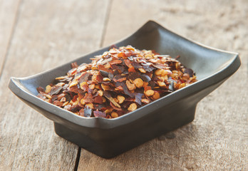 Organic spicy red pepper flakes used for cooking, selective focus