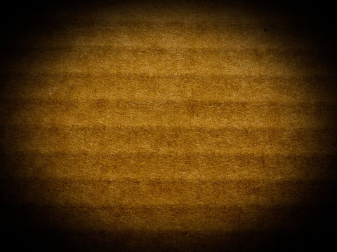 Brown corrugated cardboard background, spotlight vignetted