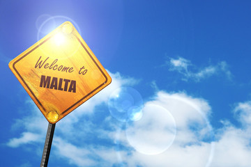 Yellow road sign with a blue sky and white clouds: Welcome to ma