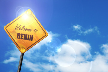 Yellow road sign with a blue sky and white clouds: Welcome to be