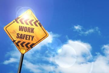 Yellow road sign with a blue sky and white clouds: Work safety s
