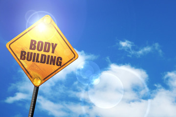 Yellow road sign with a blue sky and white clouds: bodybuilding 