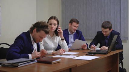 The team of young businesspeople. The meeting, brainstorming. In the office.