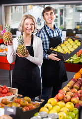 sellers posing with fruits