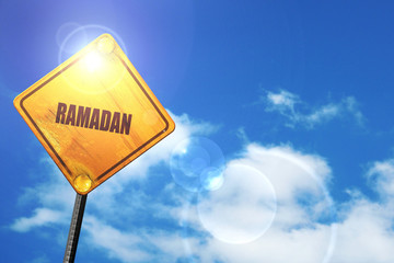 Yellow road sign with a blue sky and white clouds: Ramadan