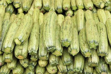 Pile of whole courgettes.