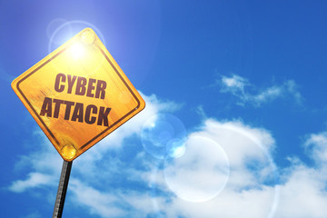 Yellow road sign with a blue sky and white clouds: Cyber attack 