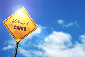 Yellow road sign with a blue sky and white clouds: Welcome to ca