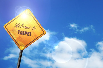 Yellow road sign with a blue sky and white clouds: Welcome to ta