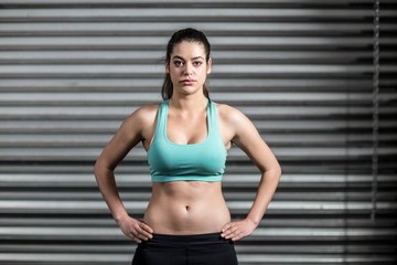 Fototapeta premium Portrait of fit woman with hands on hips