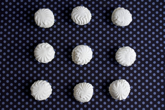 Top view of Latvian marshmallovs - zefiri on purple polka dot background
