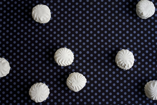 Top view of Latvian marshmallovs - zefiri on purple polka dot background