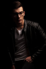 Obraz premium dark haired man in leather wearing frames, resting