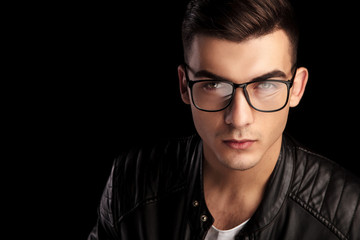 Fototapeta premium closeup shaved macho in black leather wearing glasses
