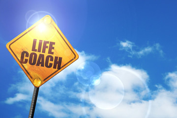 Yellow road sign with a blue sky and white clouds: life coach