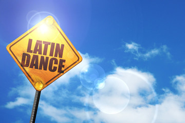 Yellow road sign with a blue sky and white clouds: latin dance