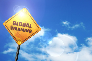 Yellow road sign with a blue sky and white clouds: global warmin