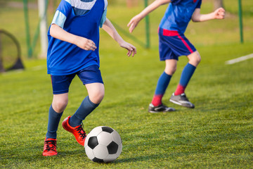 Training and football match between youth soccer teams. Young bo