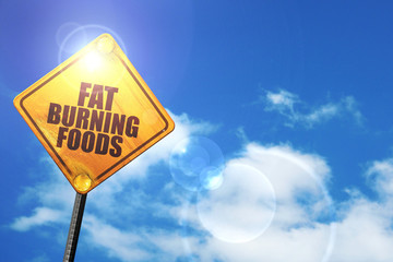 Yellow road sign with a blue sky and white clouds: fat burning f
