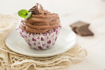 Chocolate cupcakes on white wood background