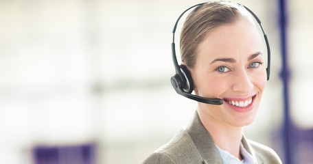 Composite image of smiling businesswoman with headset