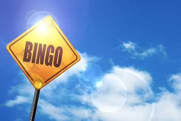 Yellow road sign with a blue sky and white clouds: bingo