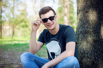 Young man relaxing in the park on a summers day