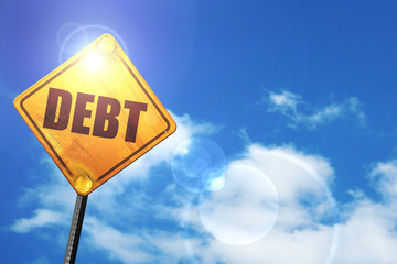 Yellow road sign with a blue sky and white clouds: Debt sign wit