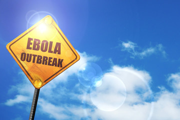 Yellow road sign with a blue sky and white clouds: Ebola outbrea