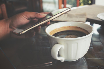 Woman drink coffee with smartphone